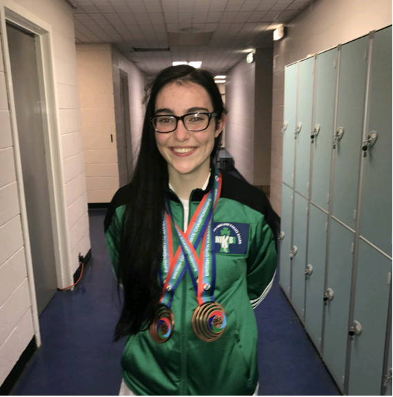 Rioghnach McGuigan festooned with medals